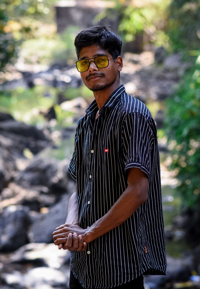 Casual portrait of a man wearing sunglasses in an outdoor setting with natural light.