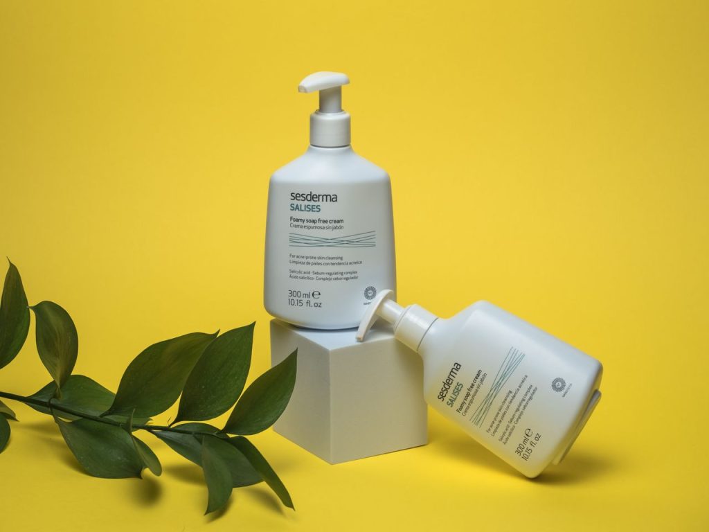 Sesderma Foamy Cream Soap displayed with modern design on bold yellow backdrop.
