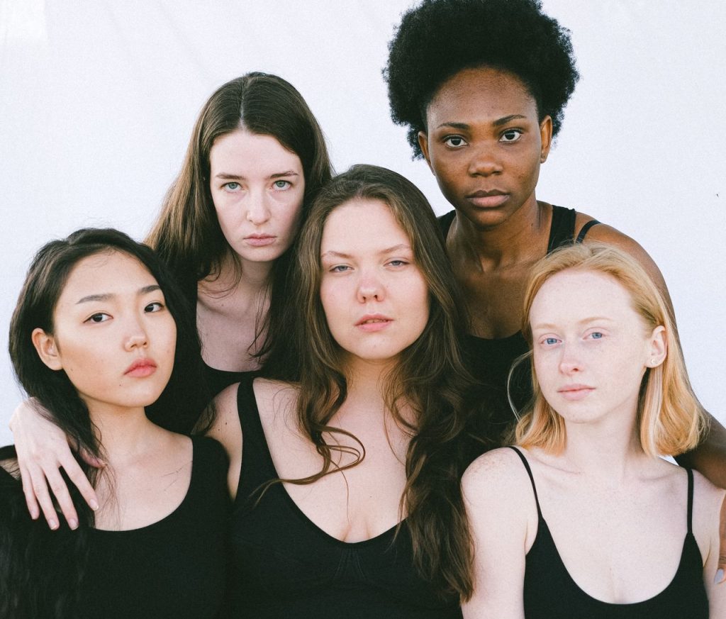 A powerful portrait of five diverse women, showcasing unity and strength in a studio setting.